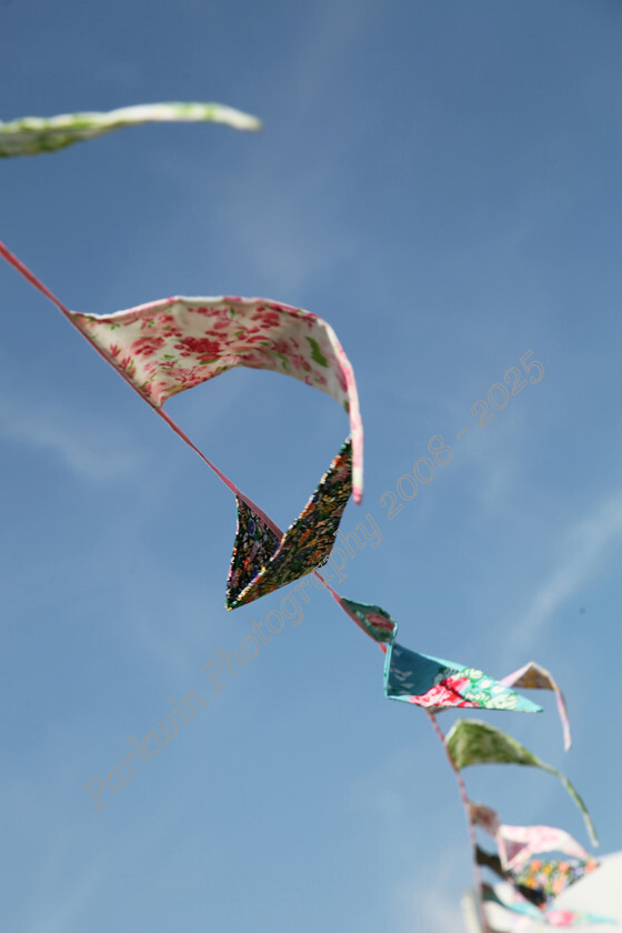 IMG 6040 
 coloured fabric bunting floating in the wind 
 Keywords: fabric bunting, wind,